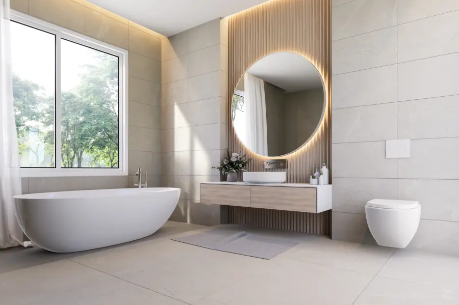 Modernes Badezimmer mit rundem Spiegel und großformatigen Wandfliesen